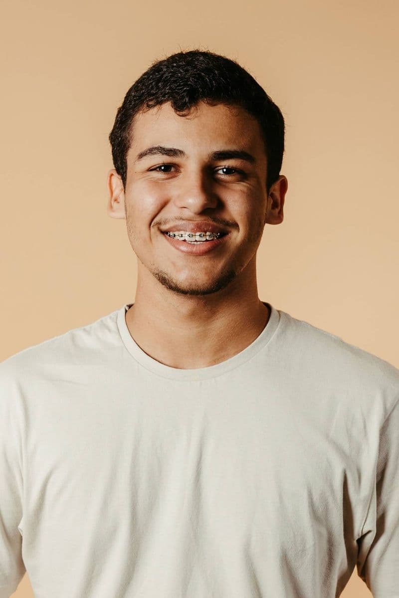 Happy young patient with braces smiling