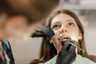 An orthodontic patient receiving treatment with fixed braces